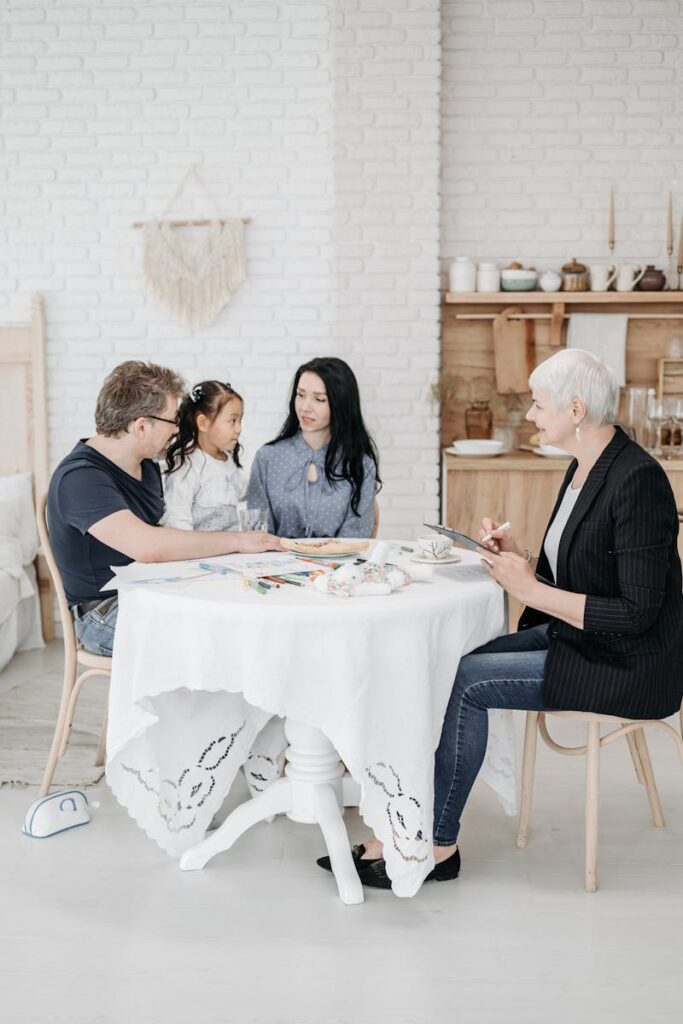 pexels-photo-8205336-8205336 A cheerful family meeting around a table in a cozy home setting, fostering bonds and conversations.